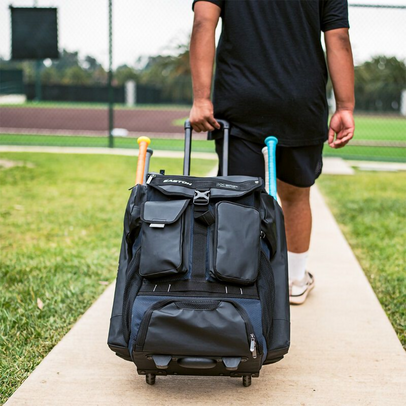 5 Tool Phenom Wheeled Bag, Easton Sports 5 Tool Phenom Wheeled Bag in Black with model in use rolling