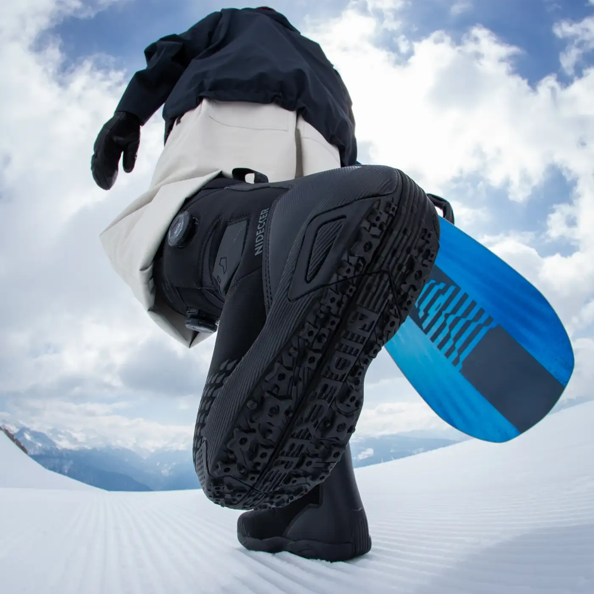Niedecker Altai bottom of boot detail on snowboarder walking with snowboard