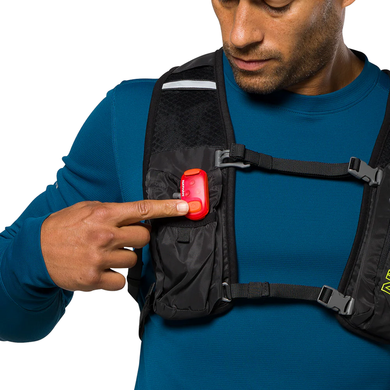 StrobeLight 2.0 Safety LED Light Clip, Nathan StrobeLight 2 on vest pushing on button