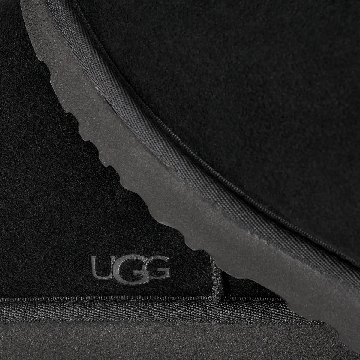 UGG Men's Classic Slip-On in Black sole and logo detail