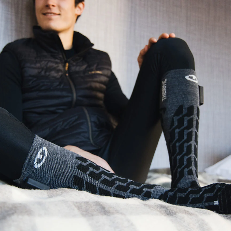 Therm-ic S-Pack 2400 in heated snow socks on rider lounging 