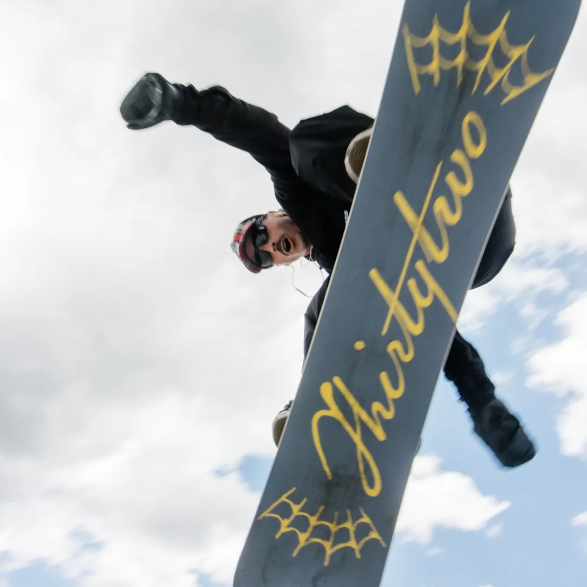ThirtyTwo Permanent Vacation snowboarder jumping over camera in action shot