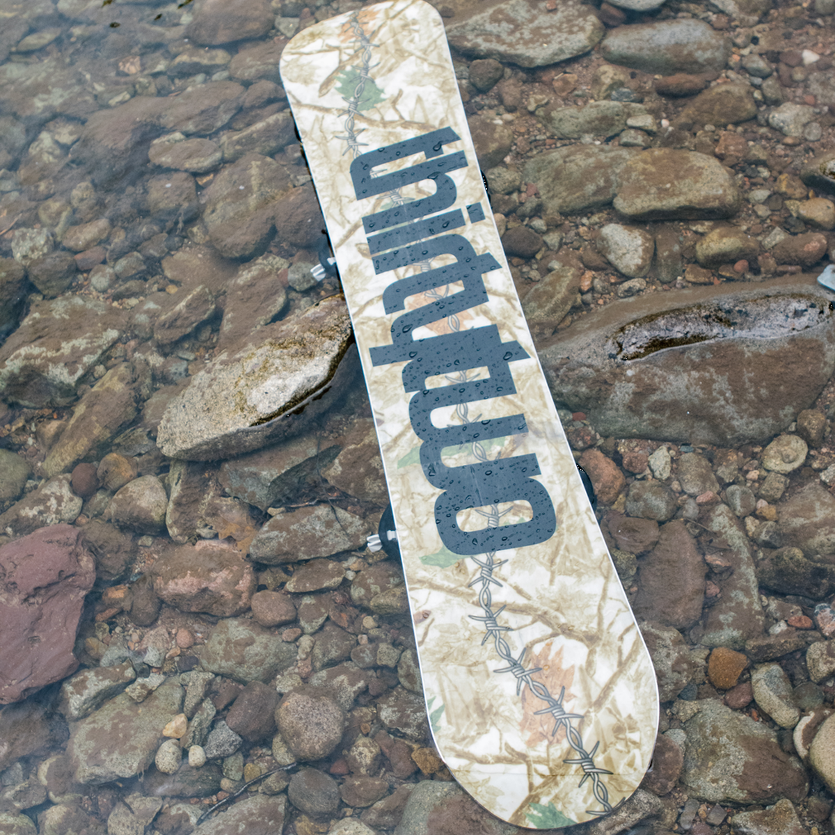 ThirtyTwo T32M base of board product shot in shallow water with rocks