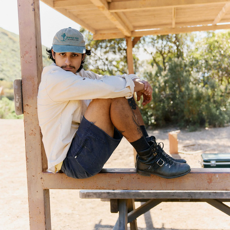 Men's Reggie Deluxe Shorts, Ripton Men's Reggie Deluxe Shorts Cutt-off in Navy on model seated right side