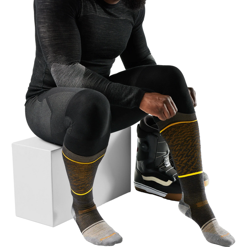 Snowboard Targeted Cushion Retro Line OTC Socks, Smartwool Snowboard Targeted Cushion Retro Line OTC Socks model putting on sock