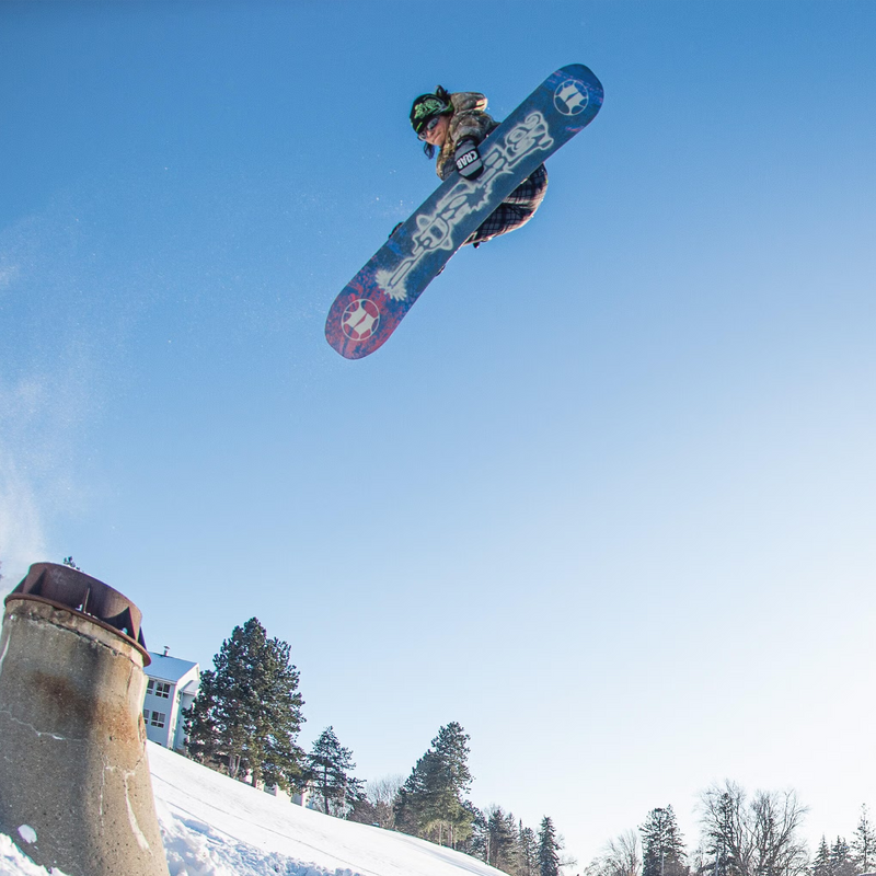 Armada Snowboards Women's Cold Press with rider in air doing grab