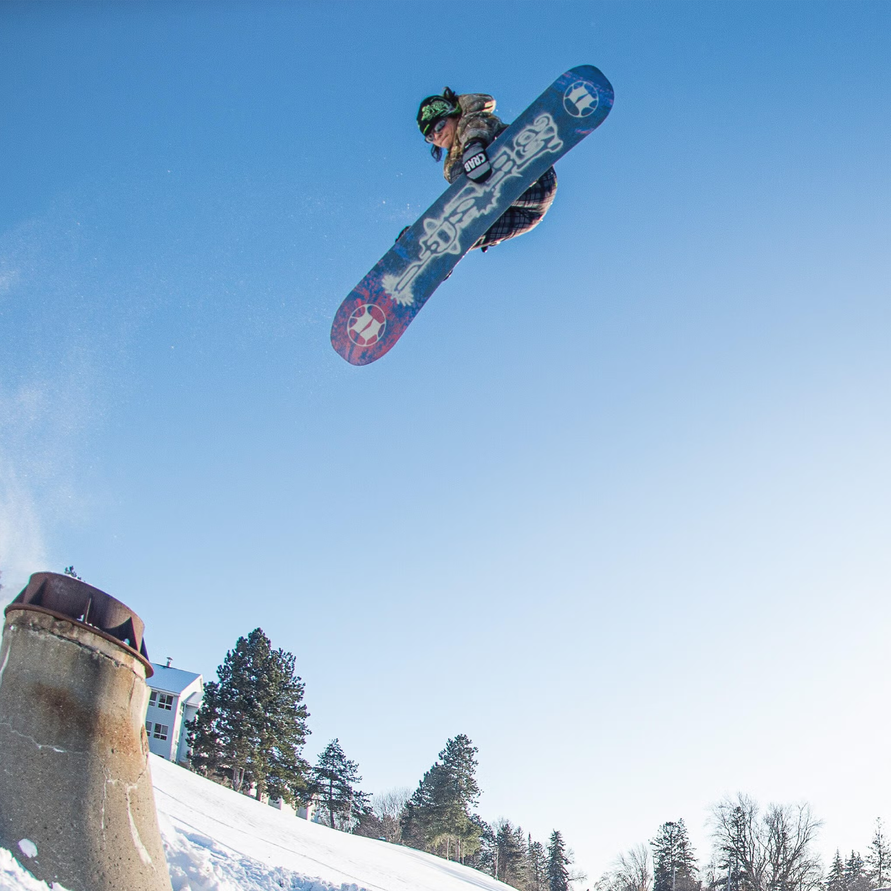 Armada Snowboards Women's Cold Press with rider in air doing grab