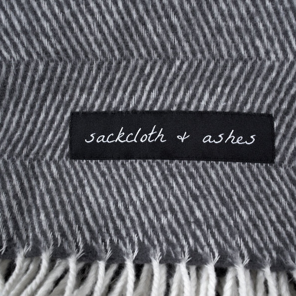Essential Blanket, Sackcloth and ashes Essential Blanket Herringbone Ashes logo